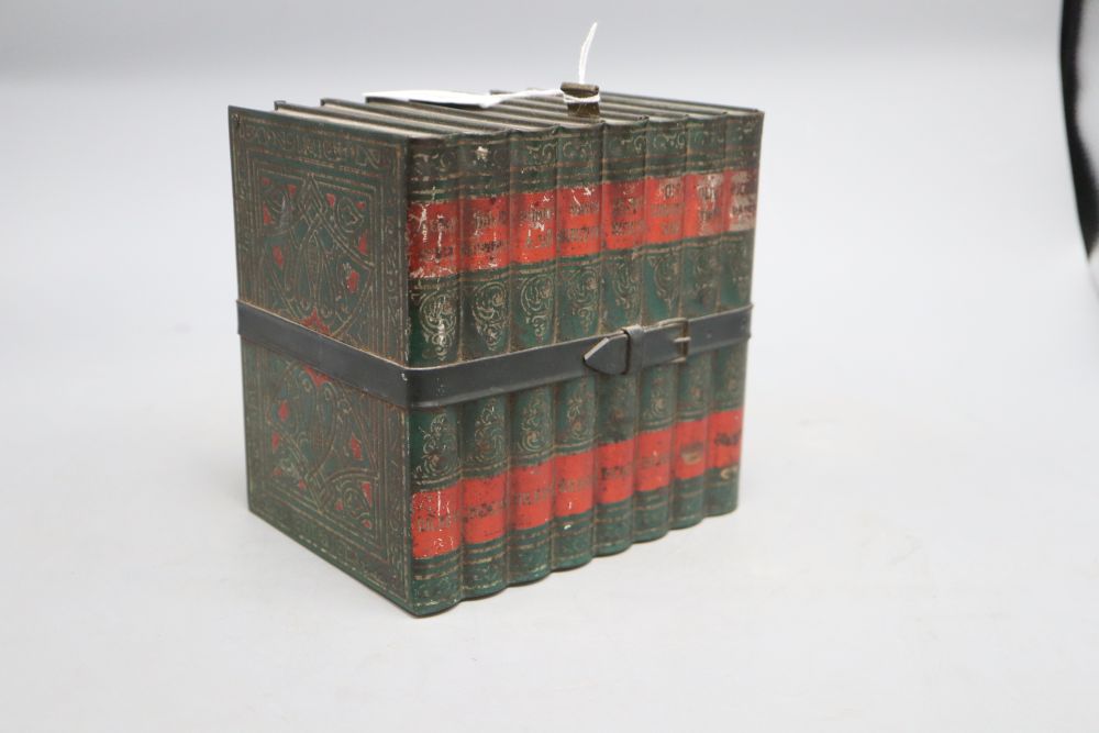 A biscuit tin in the form of eight leather bound Old Curiosity Shop books, (Huntley and Palmer), height 16cm